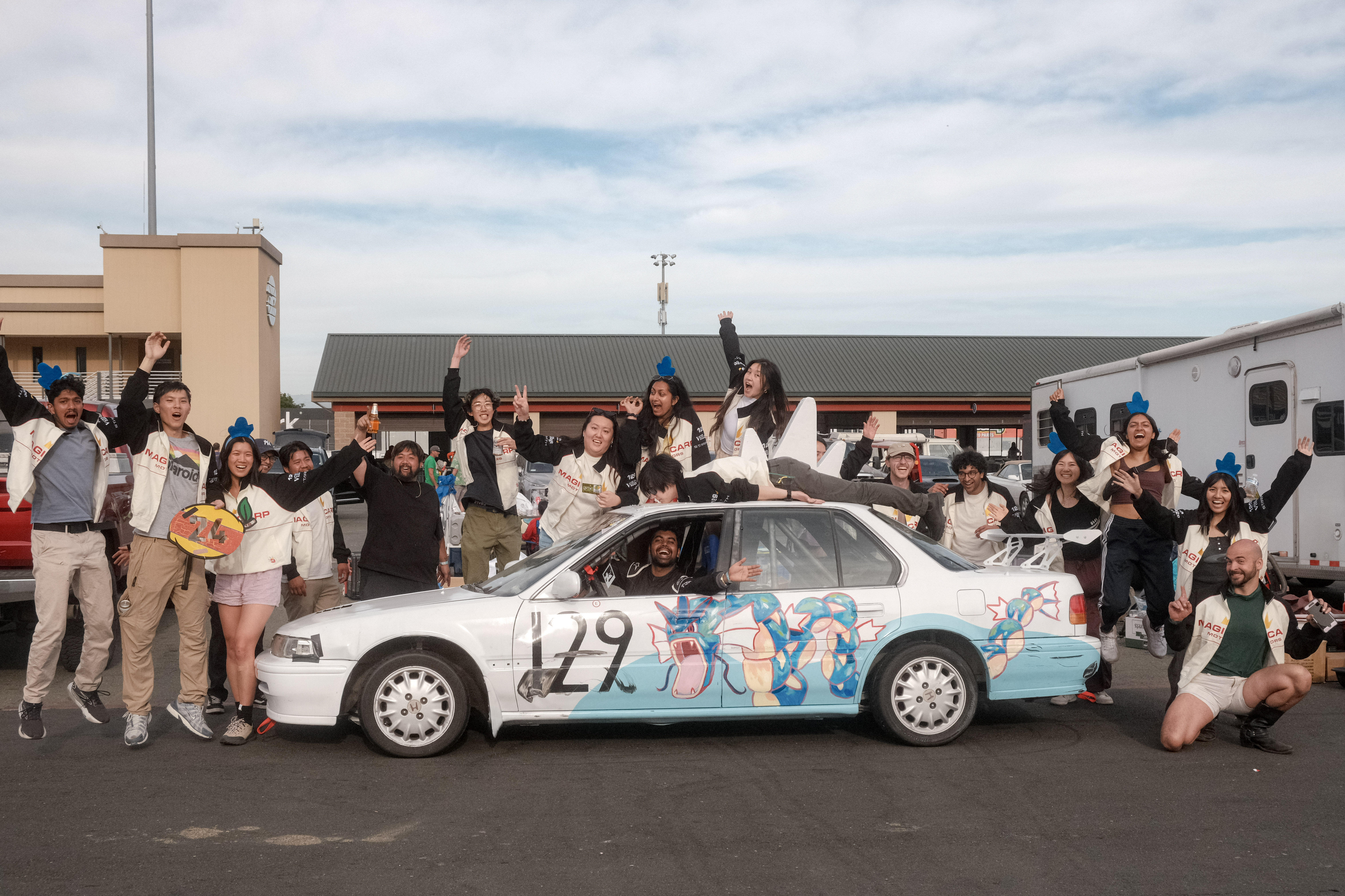 Team photo with the car at the track